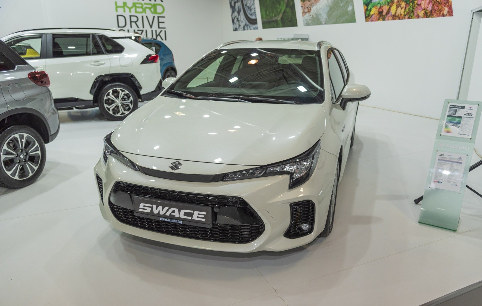 Compact hybrid hatchback front view with bold grille and sleek LED headlights.