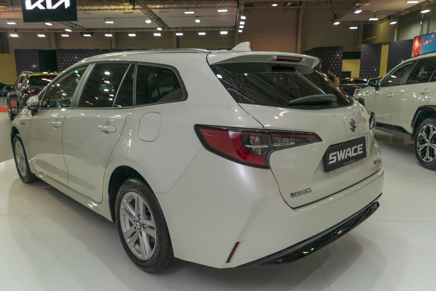 Rear and side view of hybrid station wagon with roof spoiler and modern tail lights