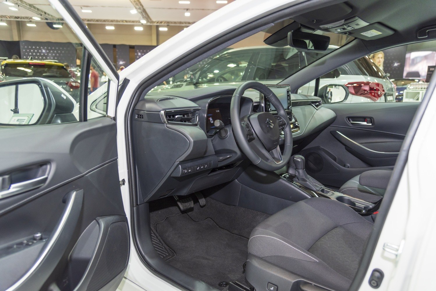 Modern car interior with dashboard, steering wheel, and gear shifter