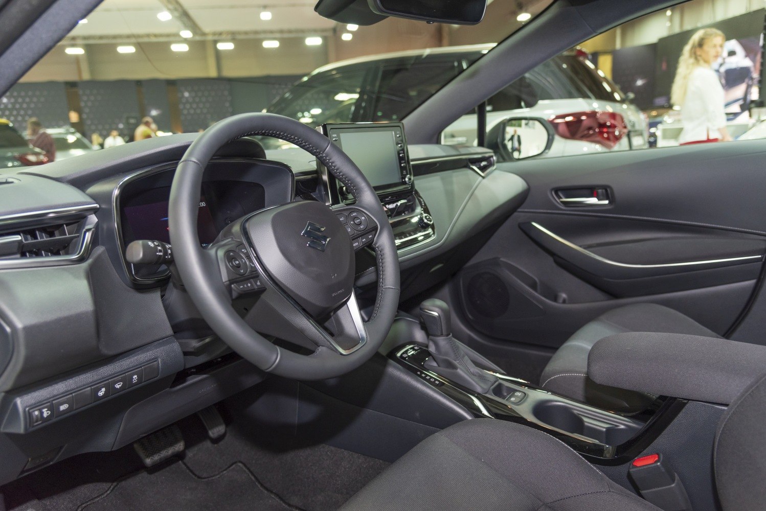 Modern car interior with dashboard, touchscreen, and ergonomic steering wheel