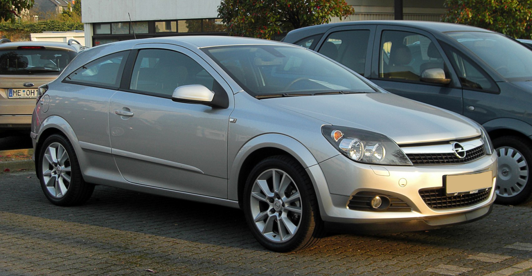 Silver 3-door coupe with alloy wheels and clear headlights