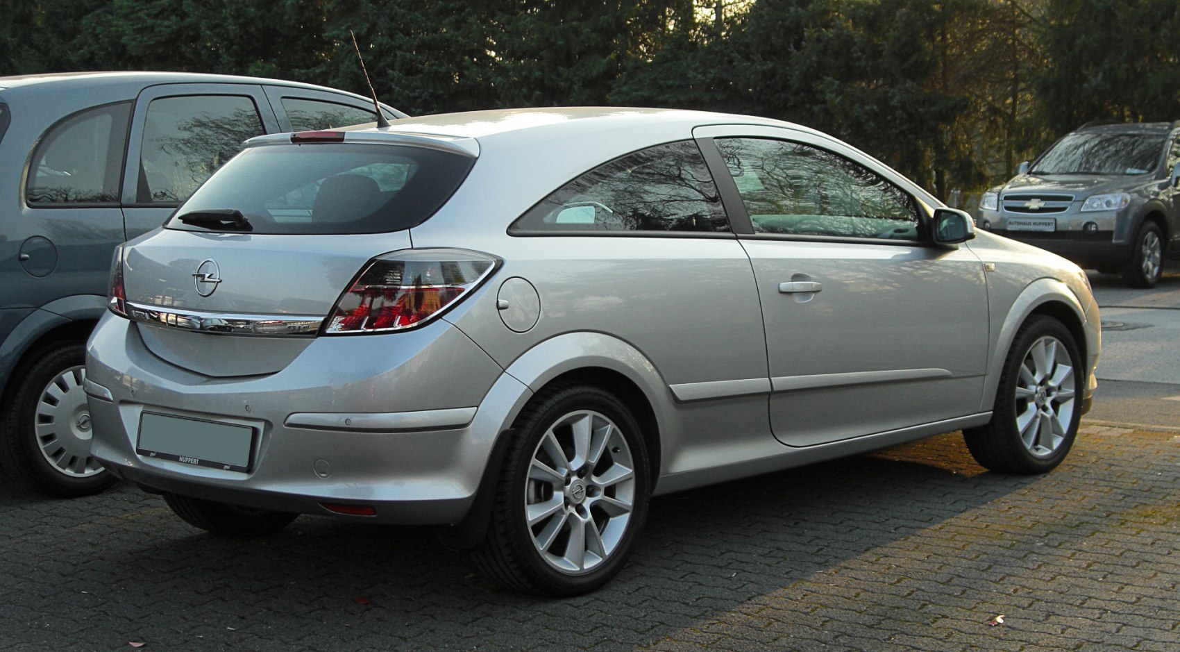 Rear side view of a silver 3-door hatchback with distinctive taillights
