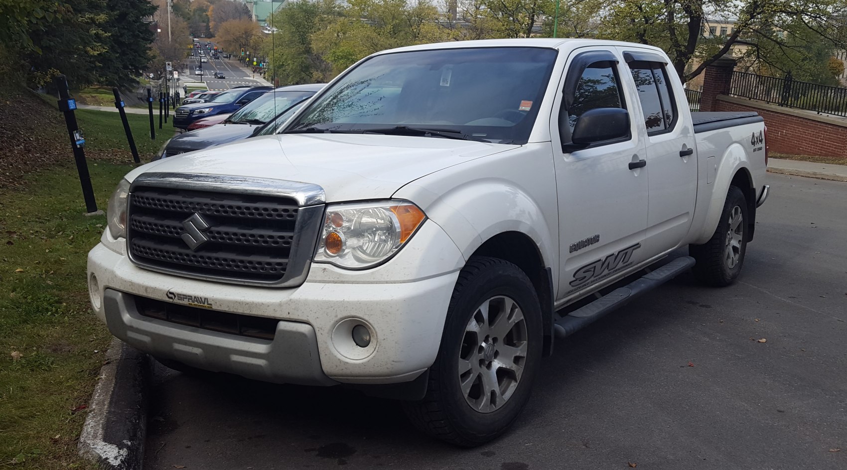 Four-door pickup with extended bed and rugged front grille design