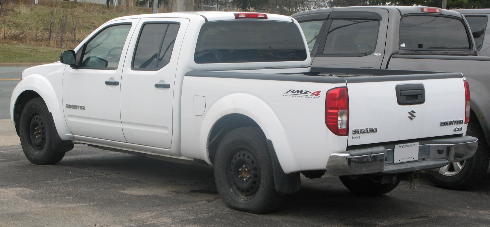 White pickup truck with crew cab, long bed and 4x4 off-road features