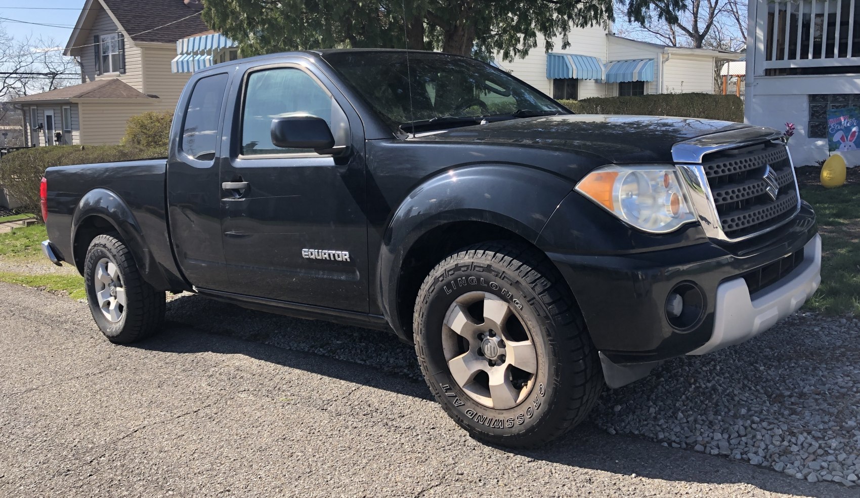 Extended cab pickup truck with off-road tires and front grille design