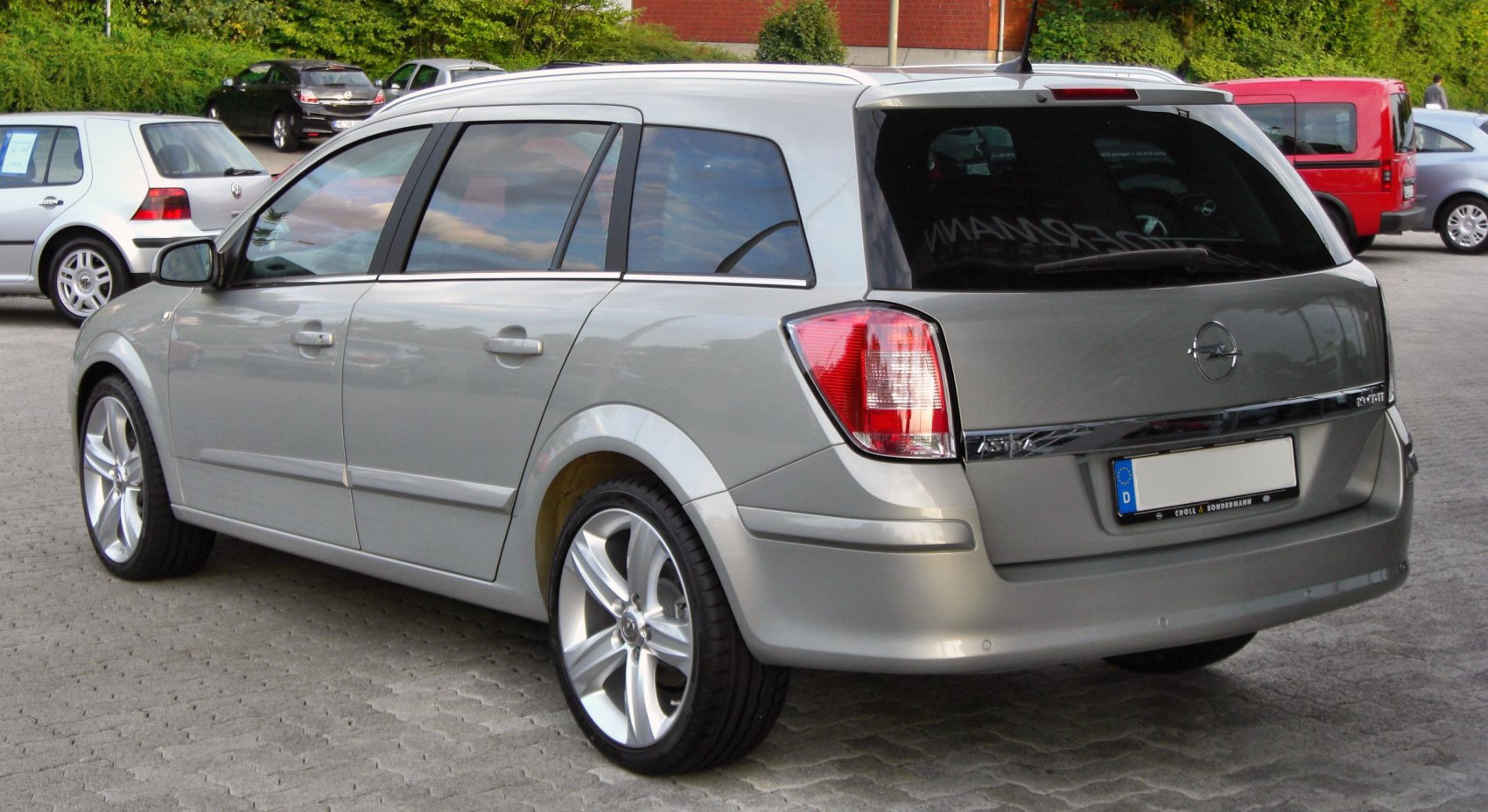 Silver estate car rear view with distinctive taillights and alloy wheels