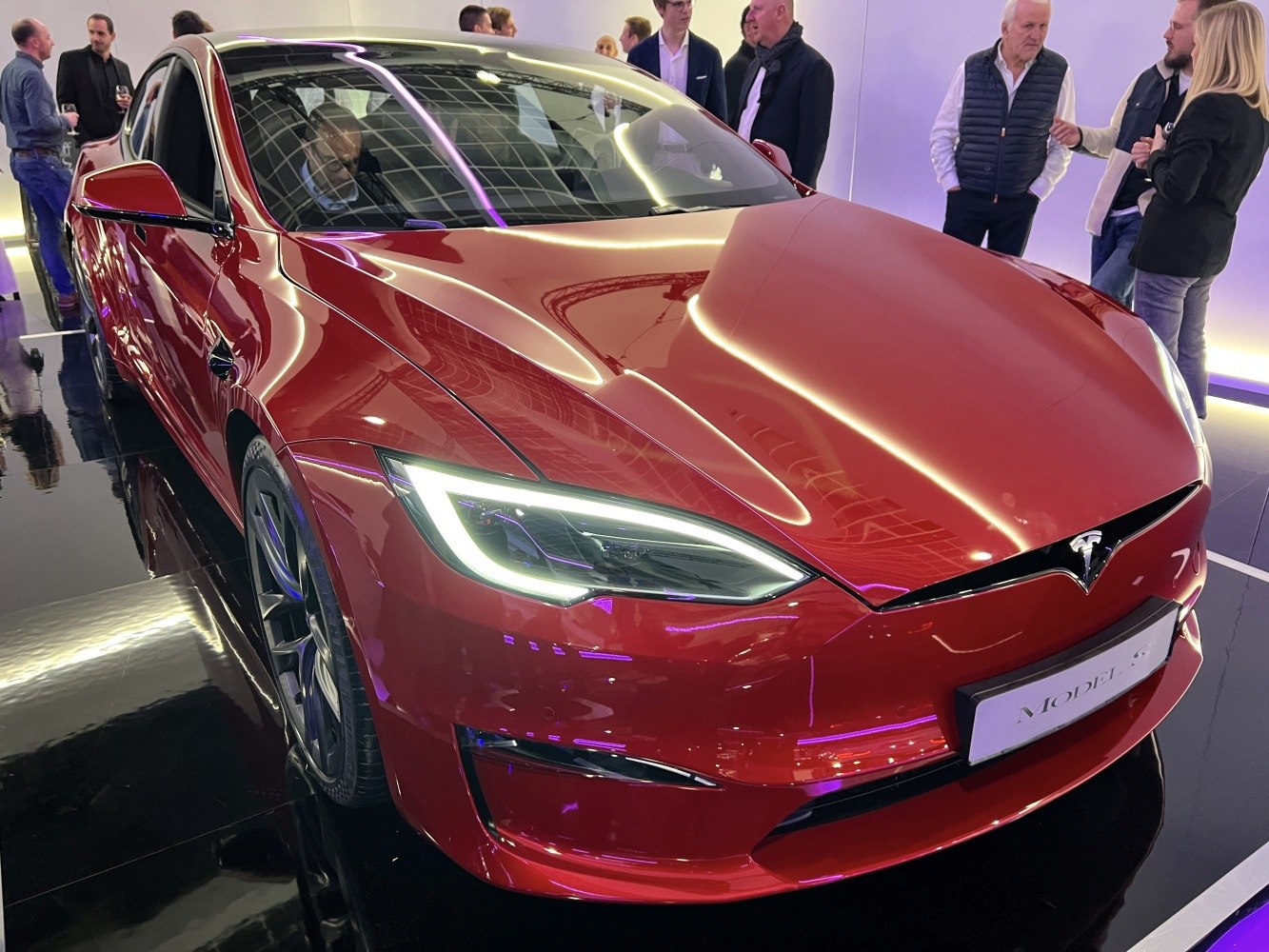 Red front angled view with LED headlights and aerodynamic design