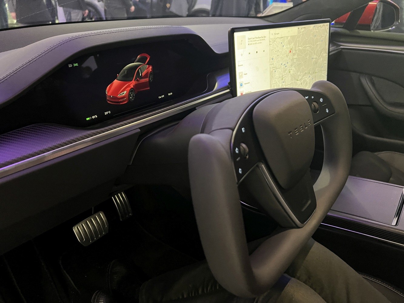 Yoke steering wheel with dual digital displays in car cockpit