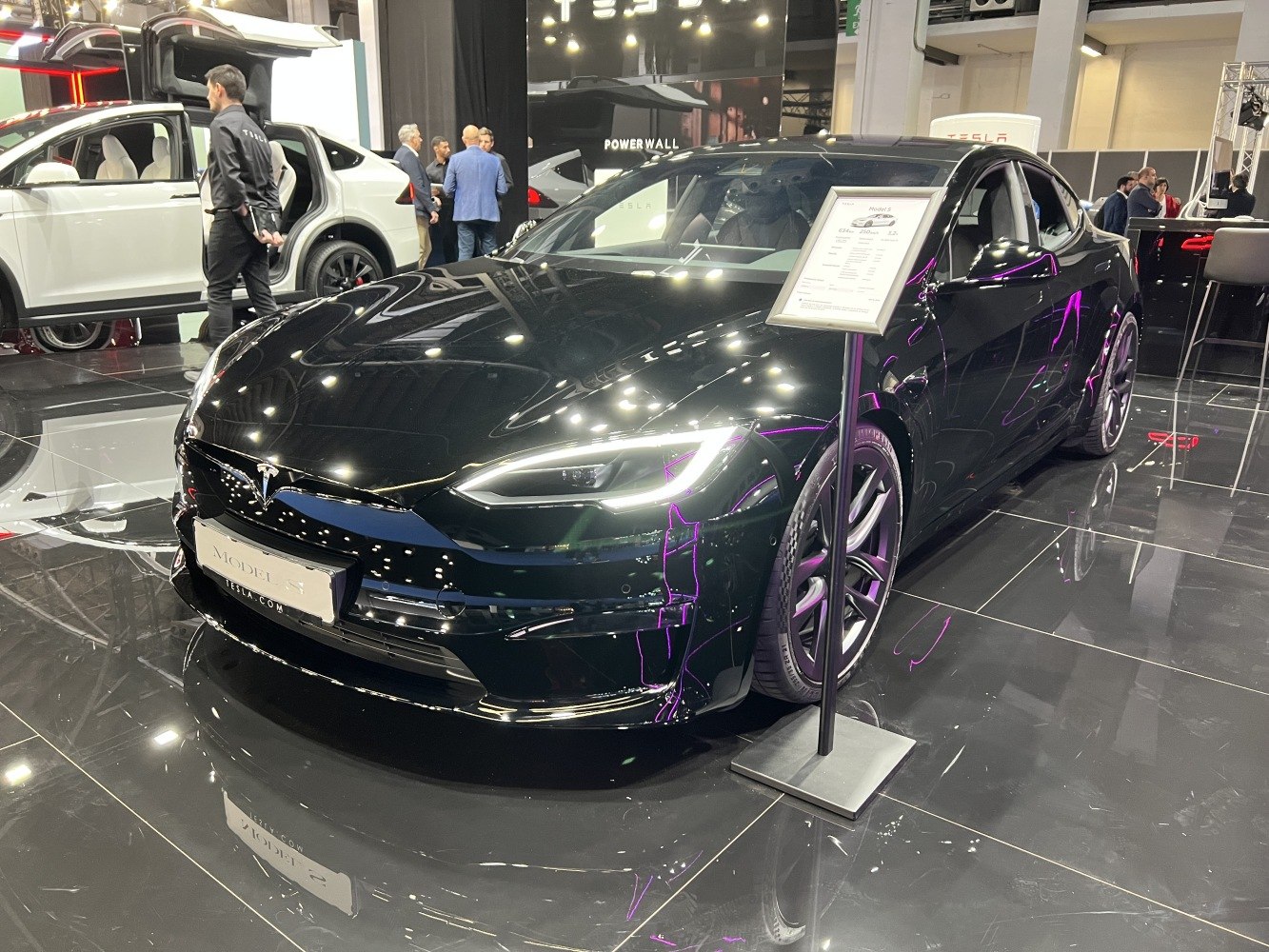 Front LED headlights and alloy wheels on sleek black sedan