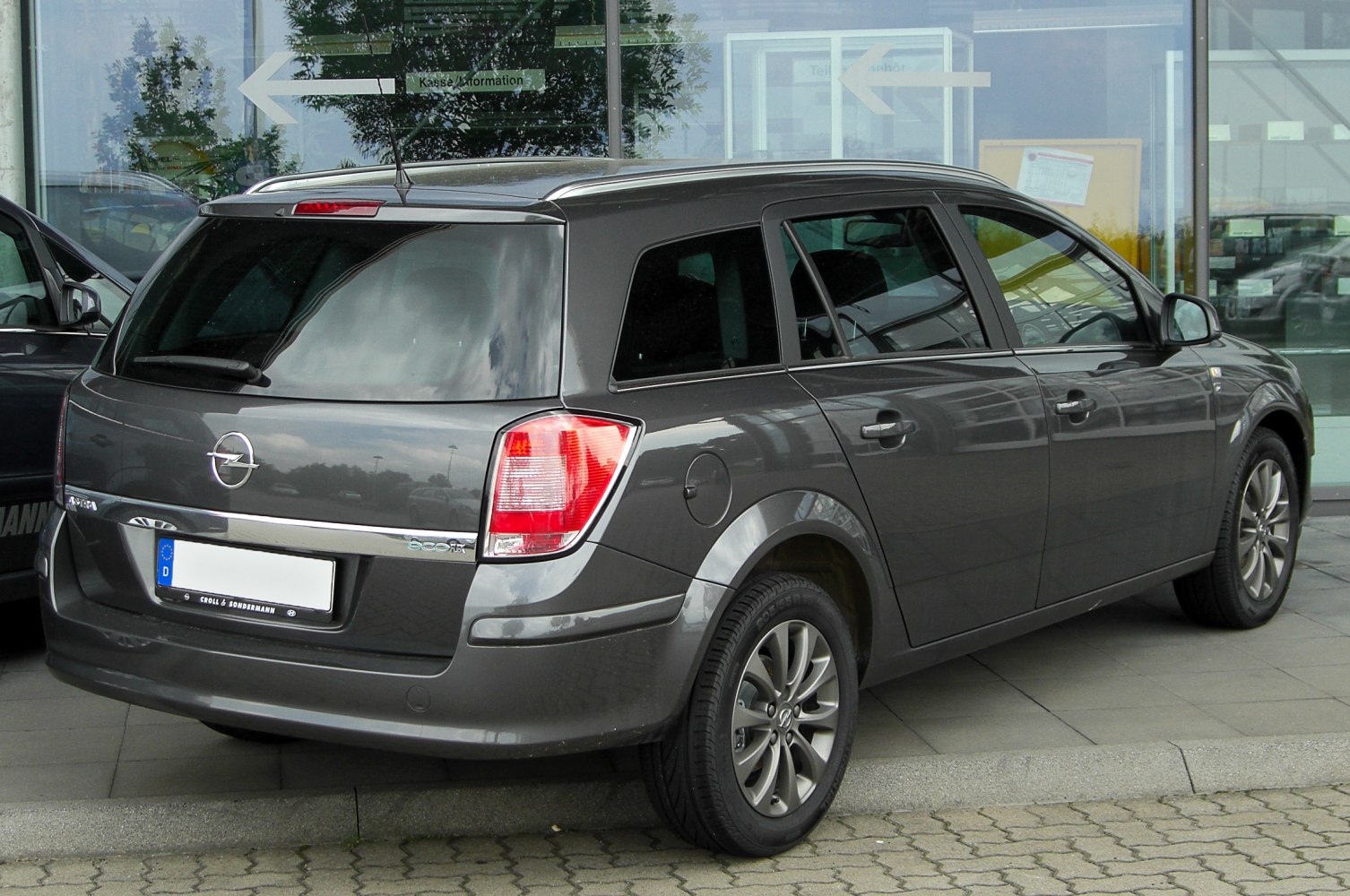 Rear side view of estate vehicle with distinct rear lights and body shape