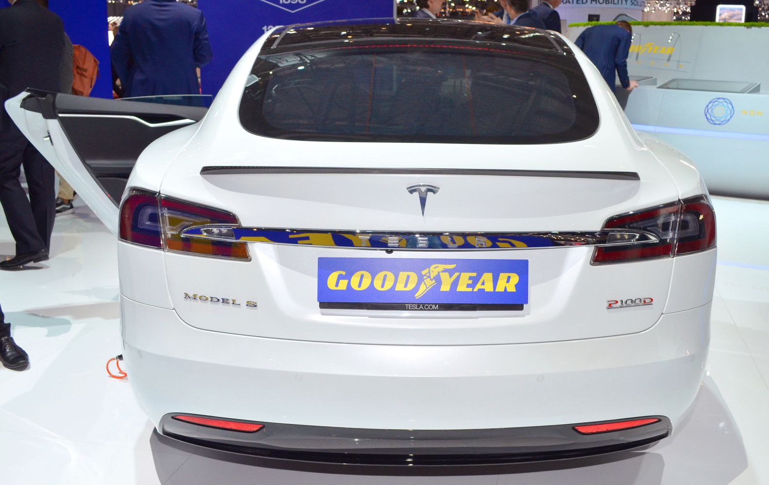 Rear view of Tesla Model S facelift with open driver door.