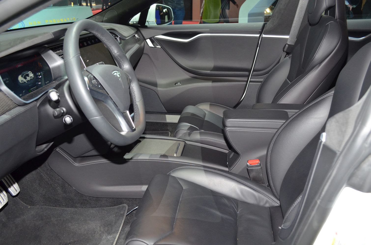 Leather seats, steering wheel, dashboard inside modern electric sedan.