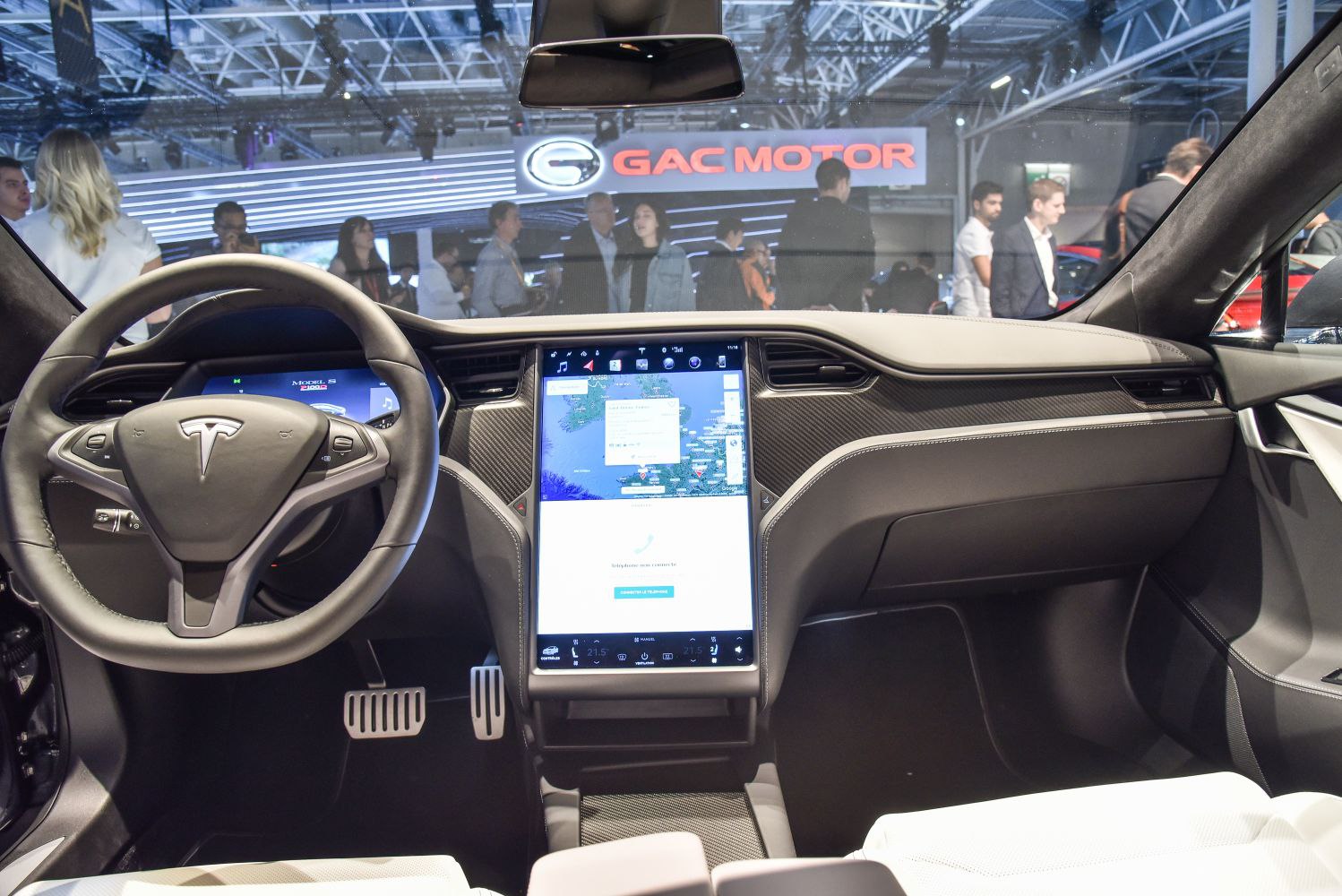 Tesla interior with digital instrument cluster and vertical touchscreen display