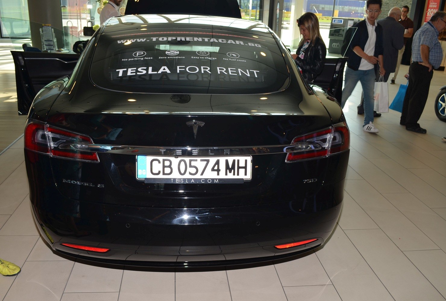 Rear view with taillights and badge of a luxury electric sedan