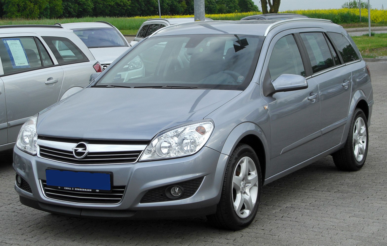 Silver station wagon with prominent headlights and front grille