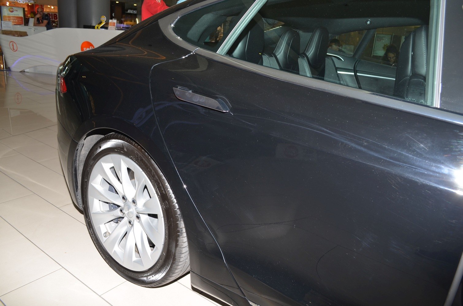 Rear door with flush handle and alloy wheel of a car