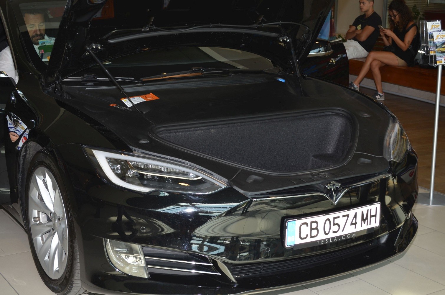 Open front trunk (frunk) with headlights and sleek hood design