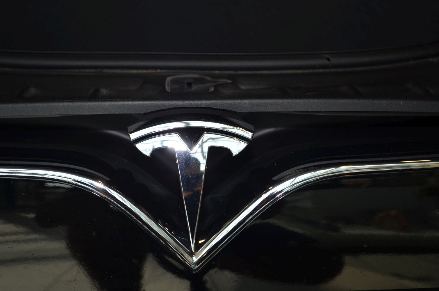 Close-up of chrome front emblem on black vehicle surface