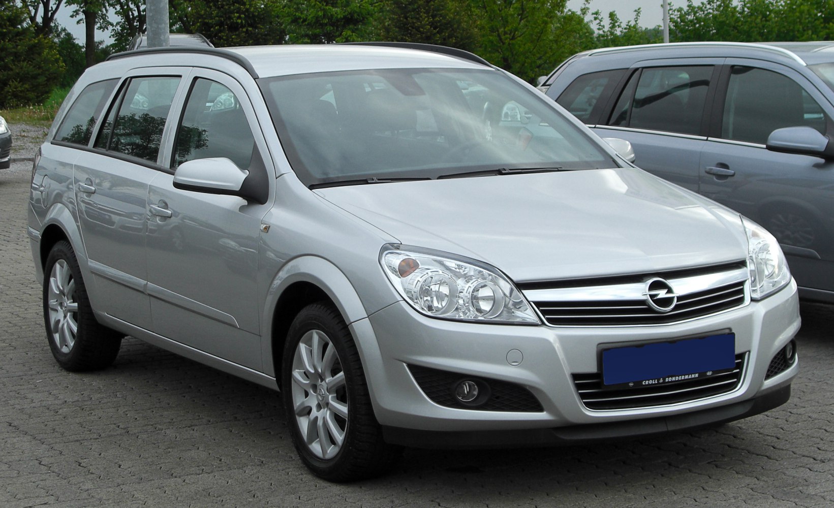 Silver station wagon with distinct headlights and chrome grille.