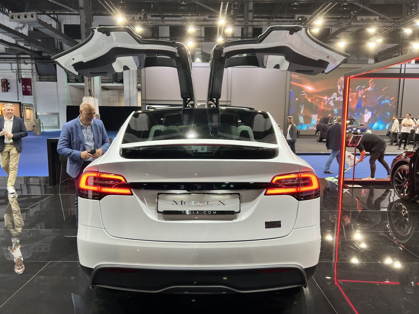 Rear view with Falcon Wing doors open and illuminated taillights