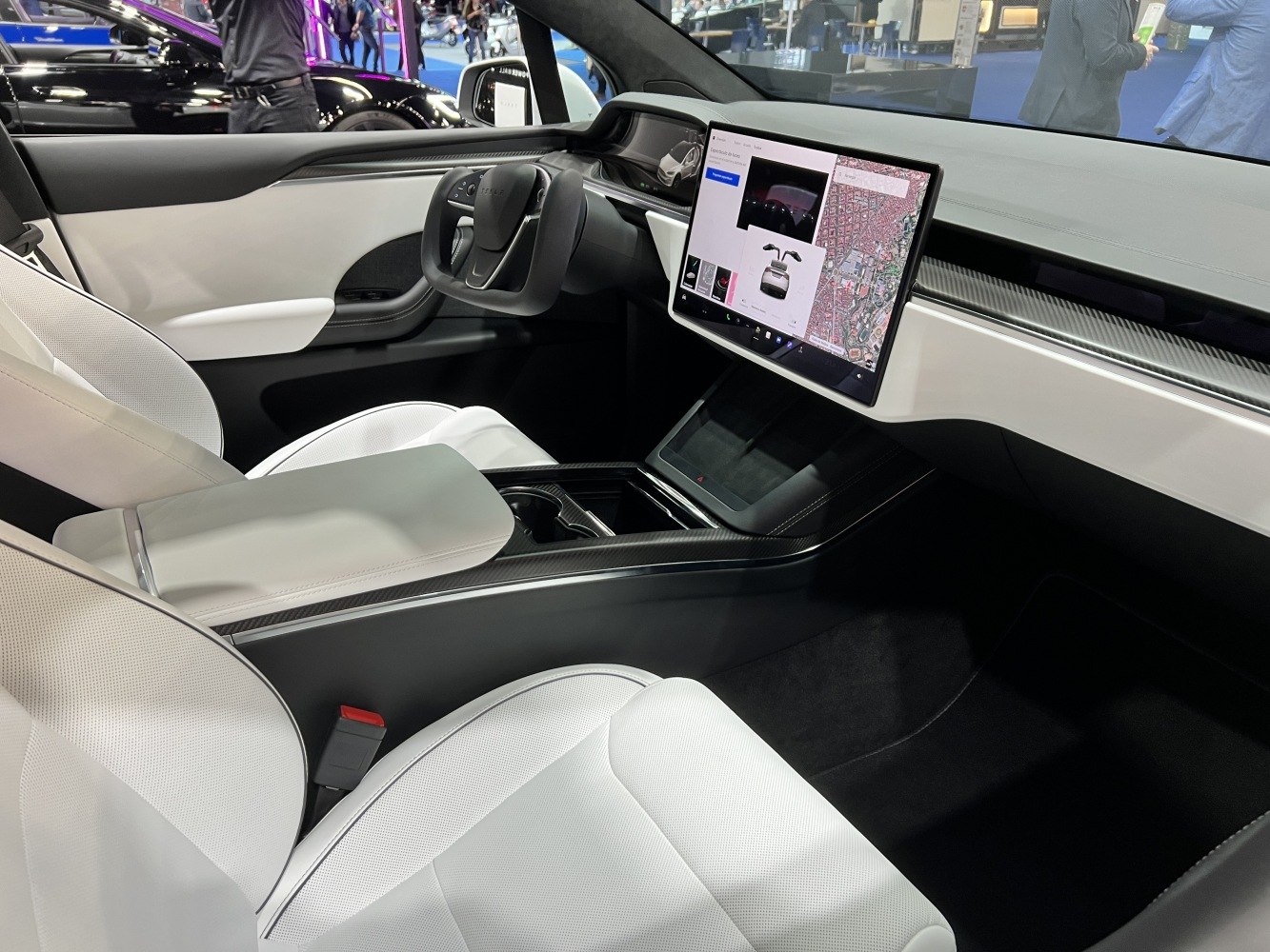 Modern EV interior with Yoke steering and large central touchscreen