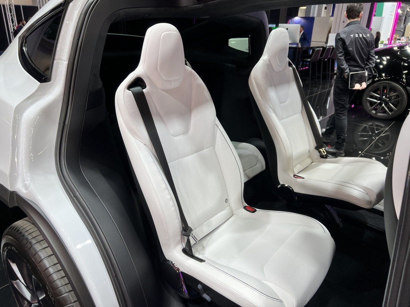 Second-row white seats with seatbelts in a modern electric SUV interior
