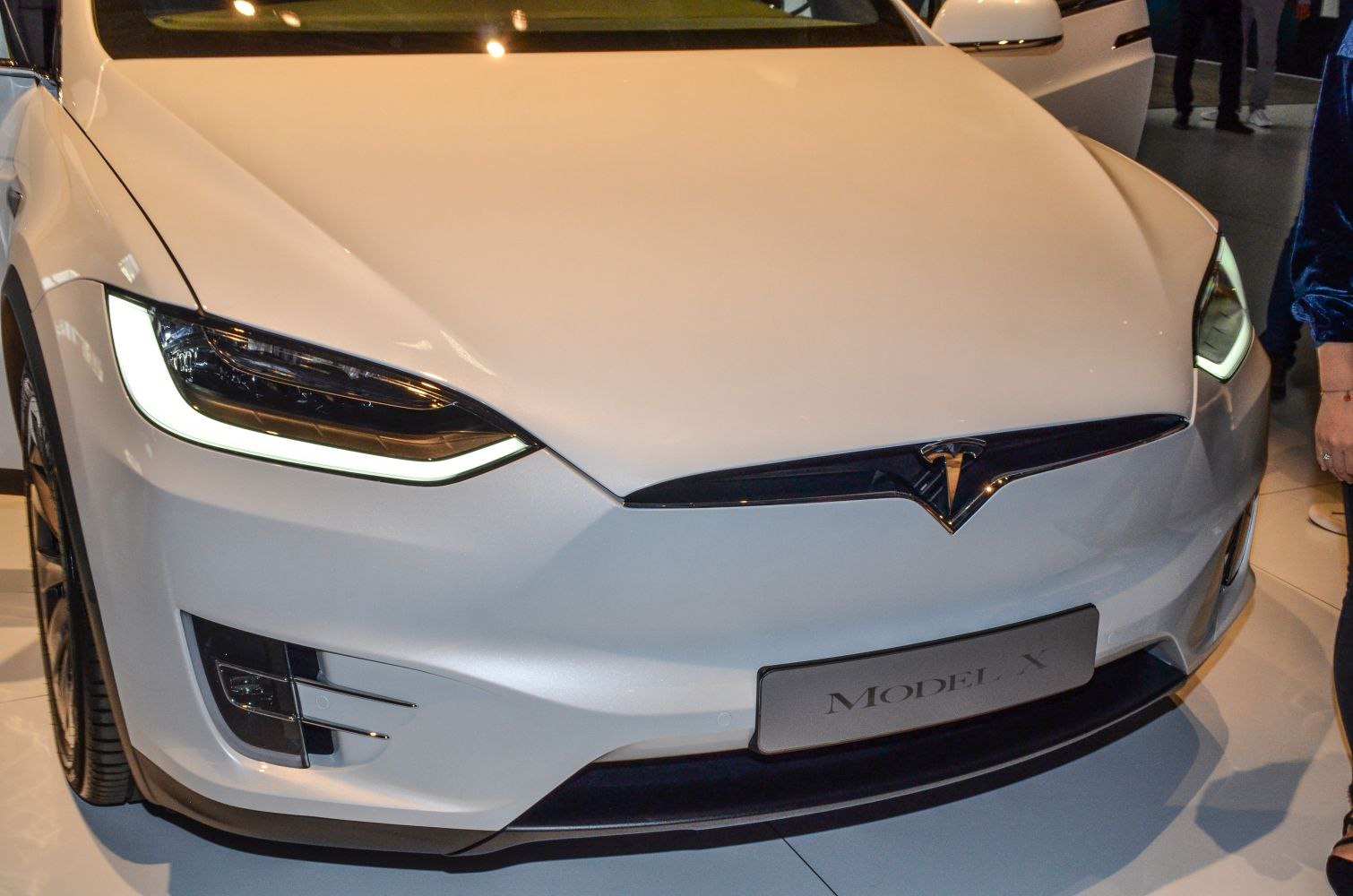 Front view with LED headlights and Tesla badge on white vehicle