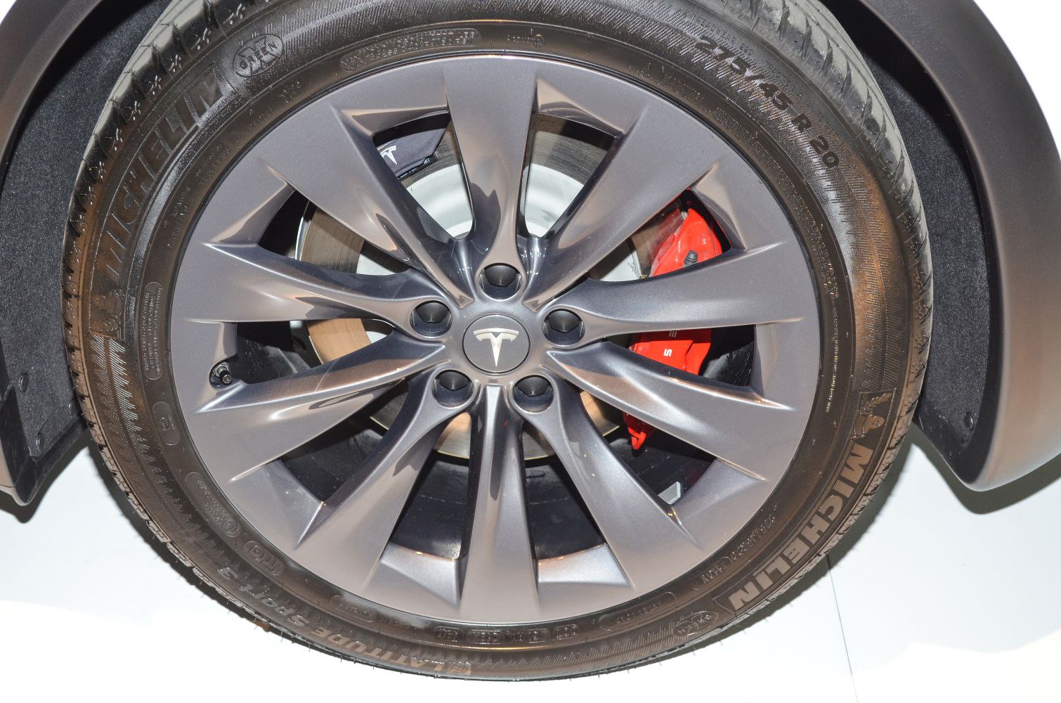Alloy wheel with red brake caliper and Michelin tire