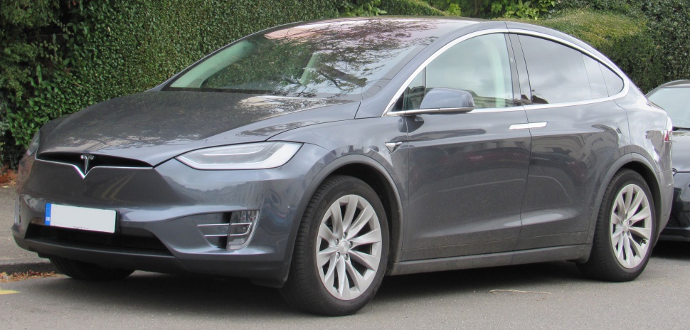 Front-side view of electric SUV with aerodynamic shape and sleek headlights