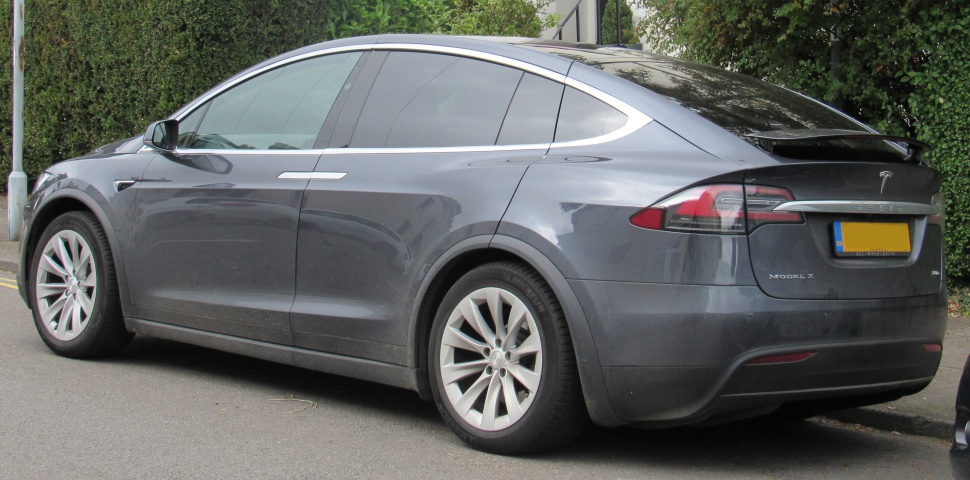 Rear and side view of a sleek electric SUV with tinted windows and alloy wheels