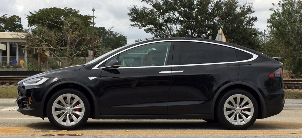 Side profile of sleek electric SUV with falcon wing door design