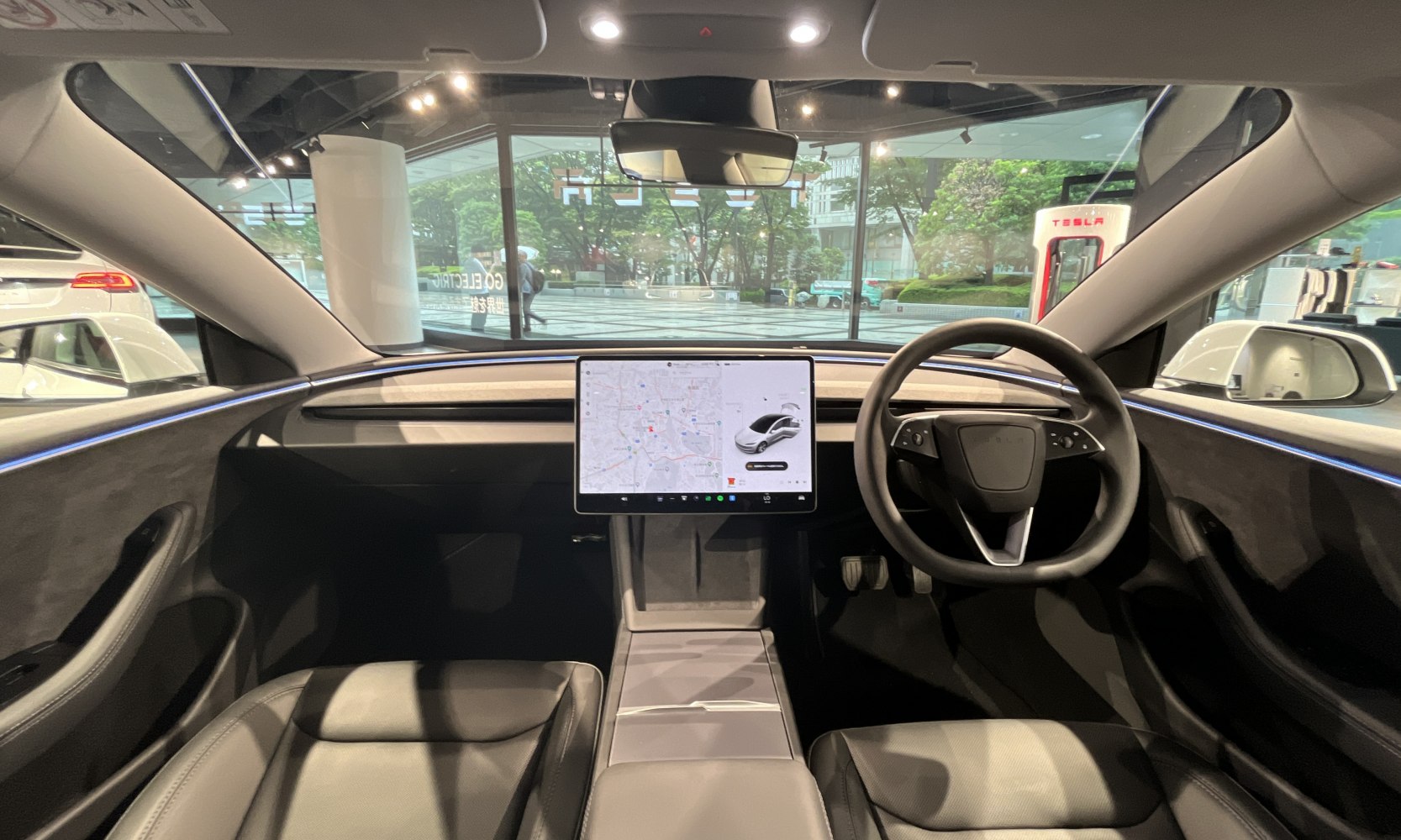 Minimalist dashboard with central touchscreen and modern steering wheel