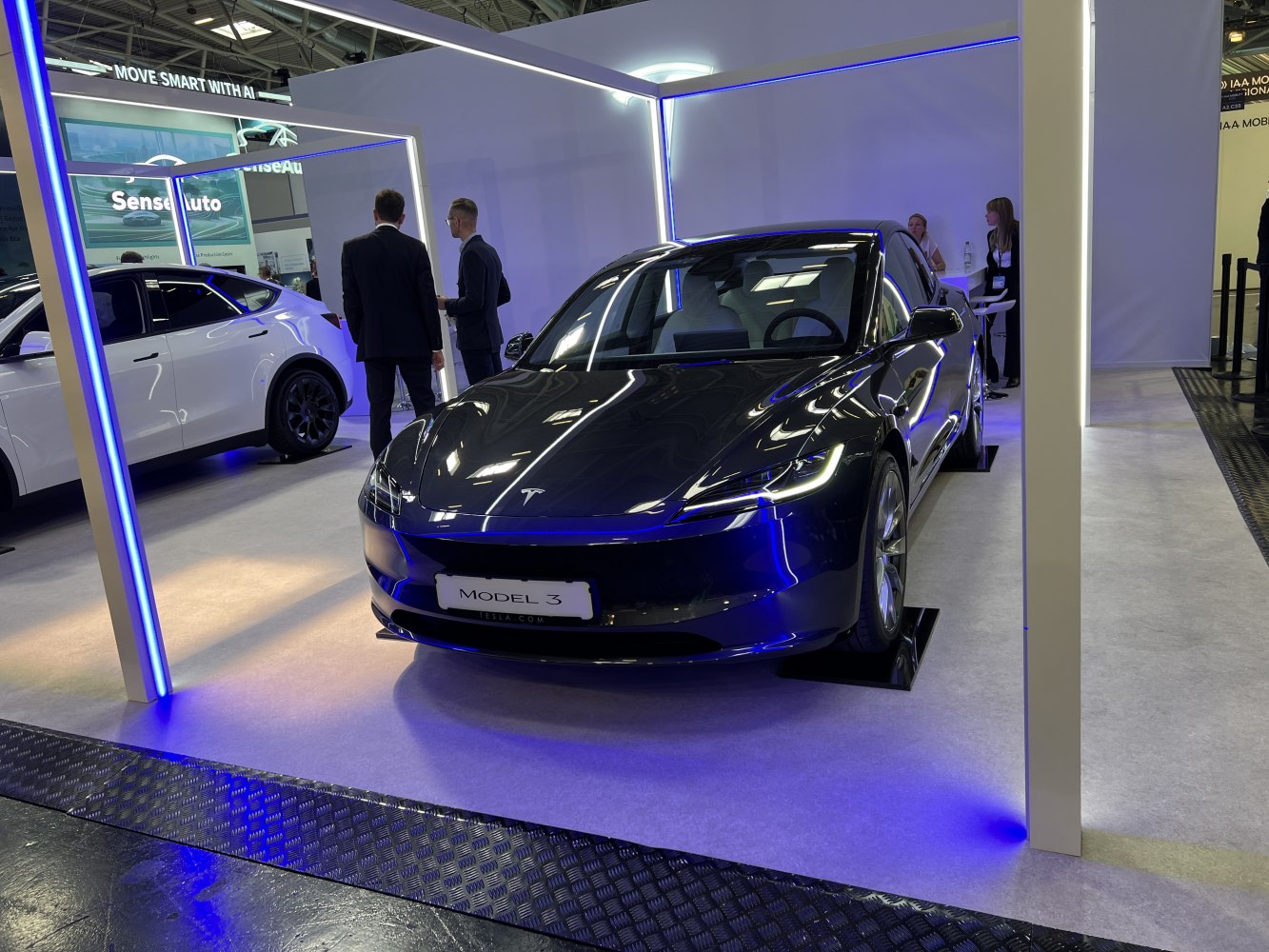 Front view of electric sedan with sleek LED headlights and modern design