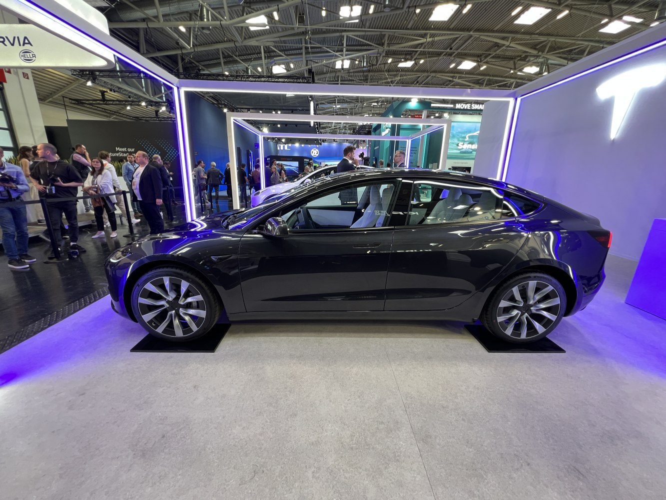 Sleek side profile with modern multi-spoke wheels under showroom lighting