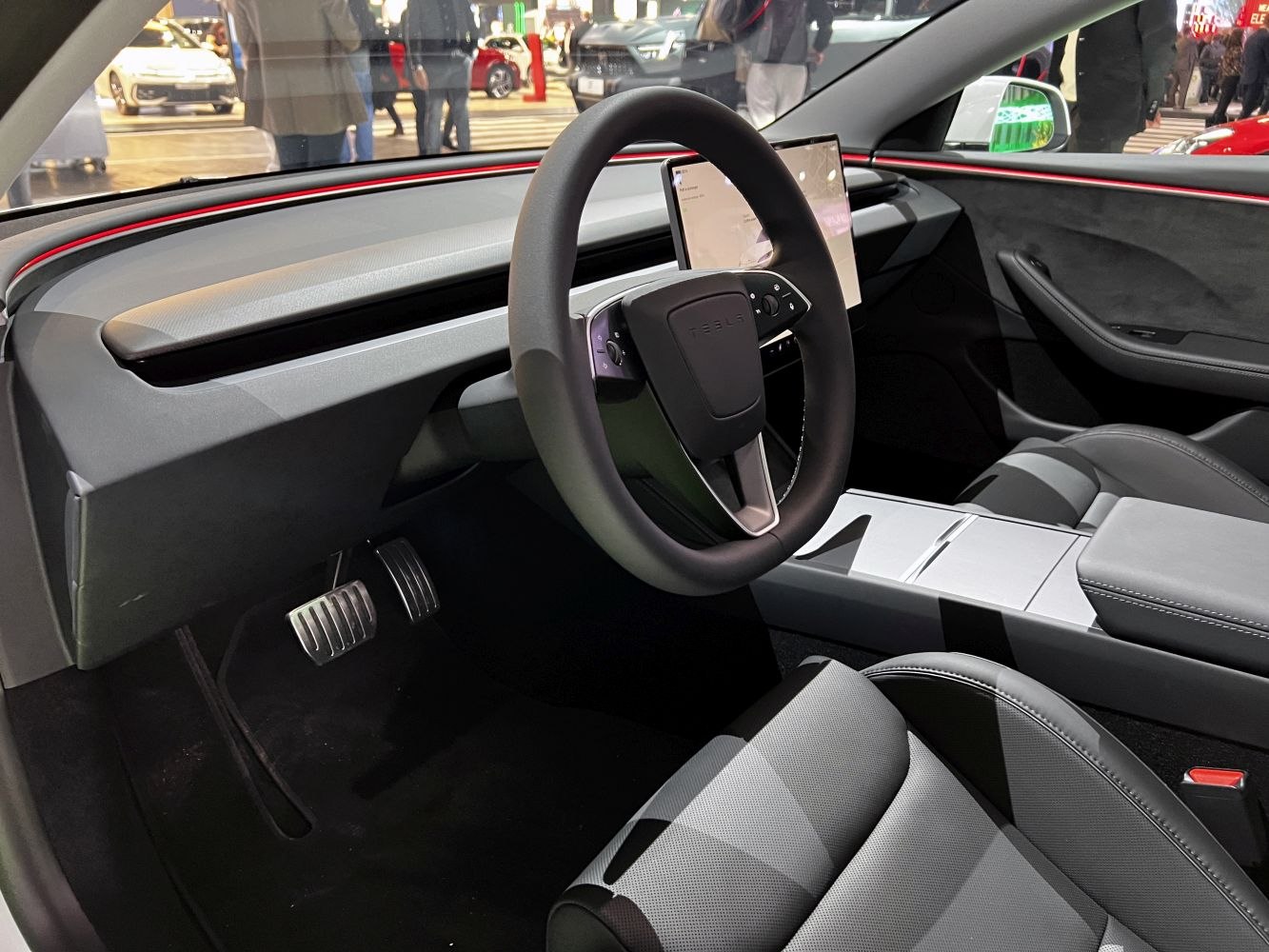Minimalist dashboard and unique yoke-style steering wheel.