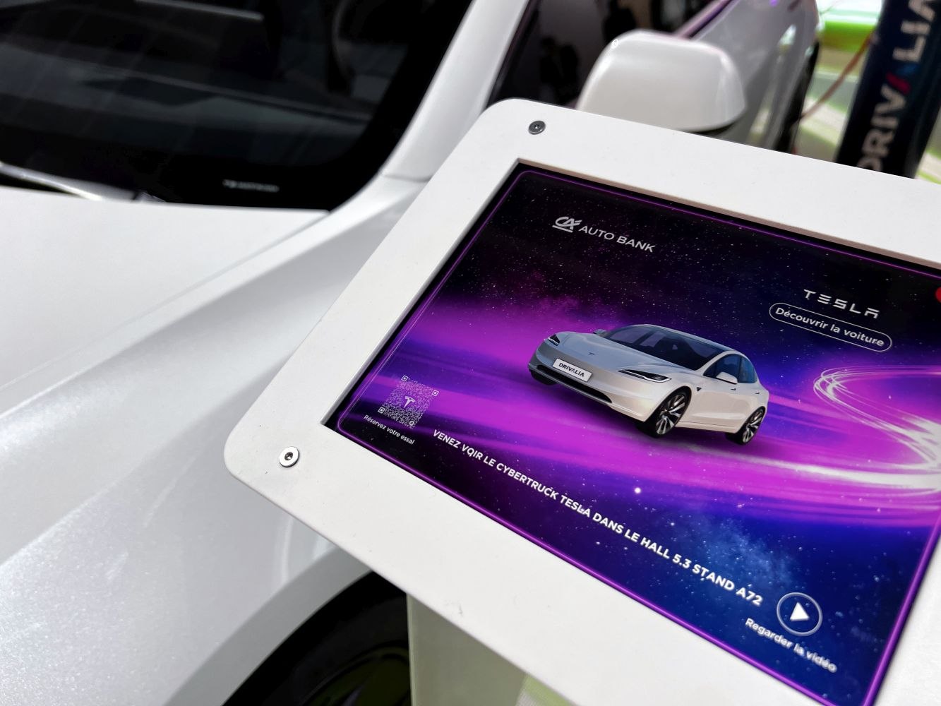 Digital display of Tesla Model 3 facelift 2023 with electric sedan front view