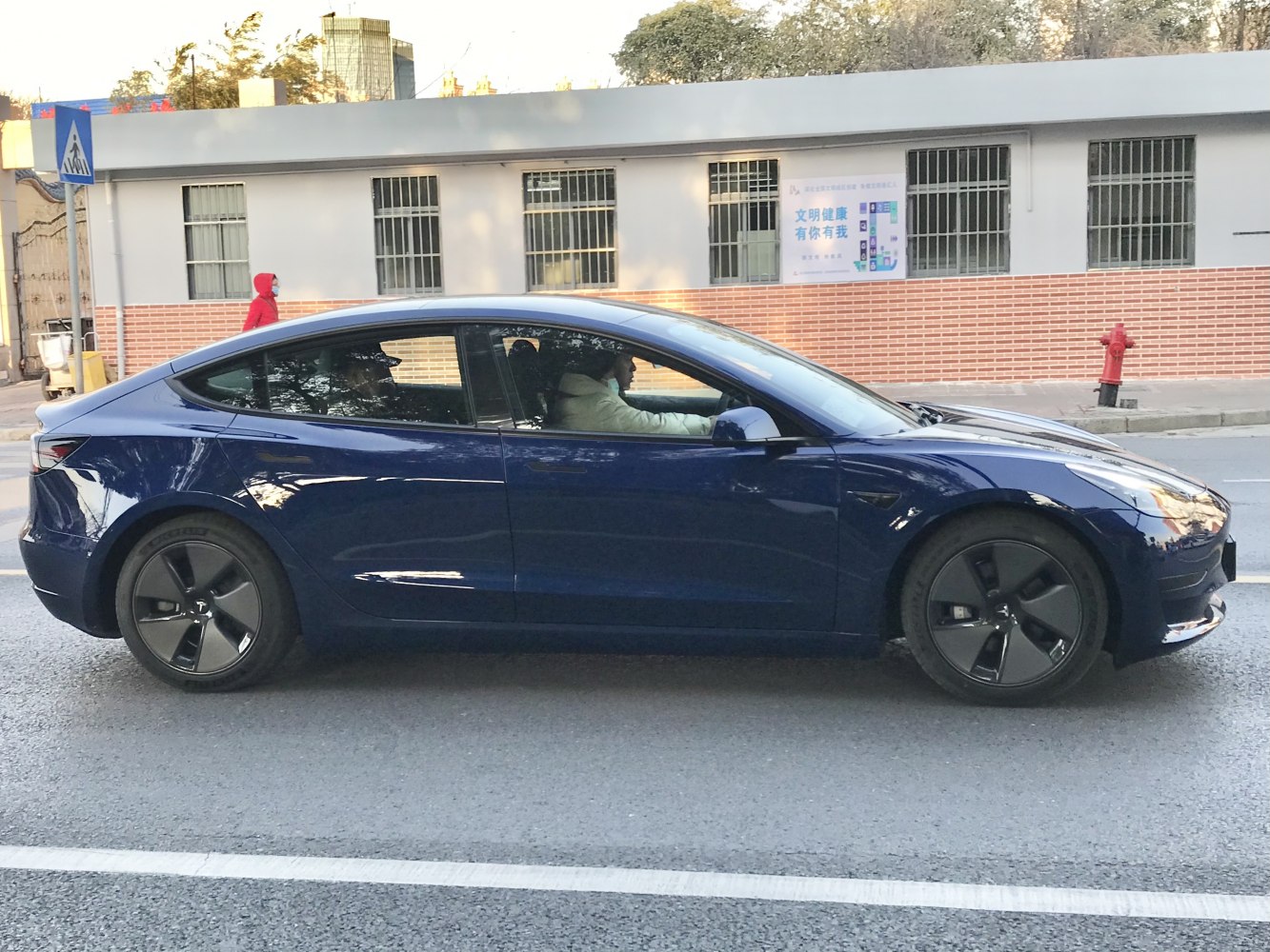 Side profile of a sleek electric sedan with aero wheels