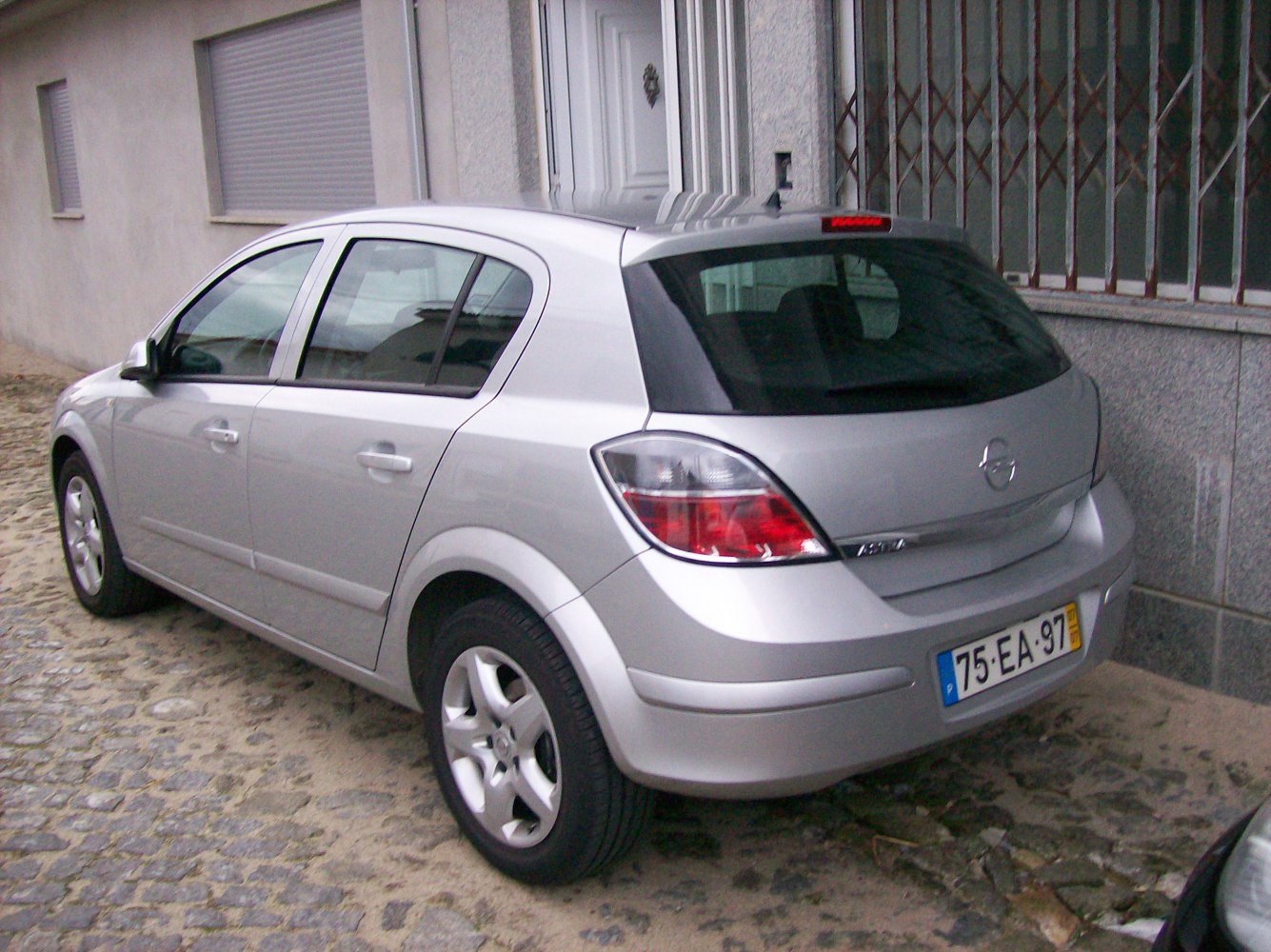 Silver five-door hatchback with distinctive taillights and rear side view