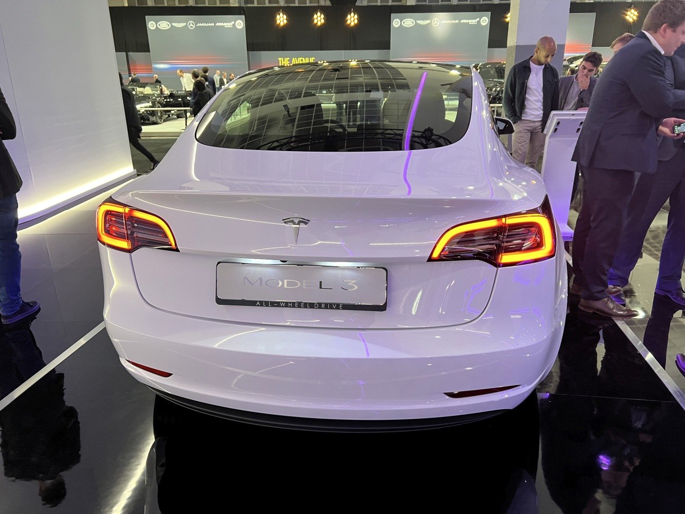 Rear view with illuminated LED taillights and sleek trunk design