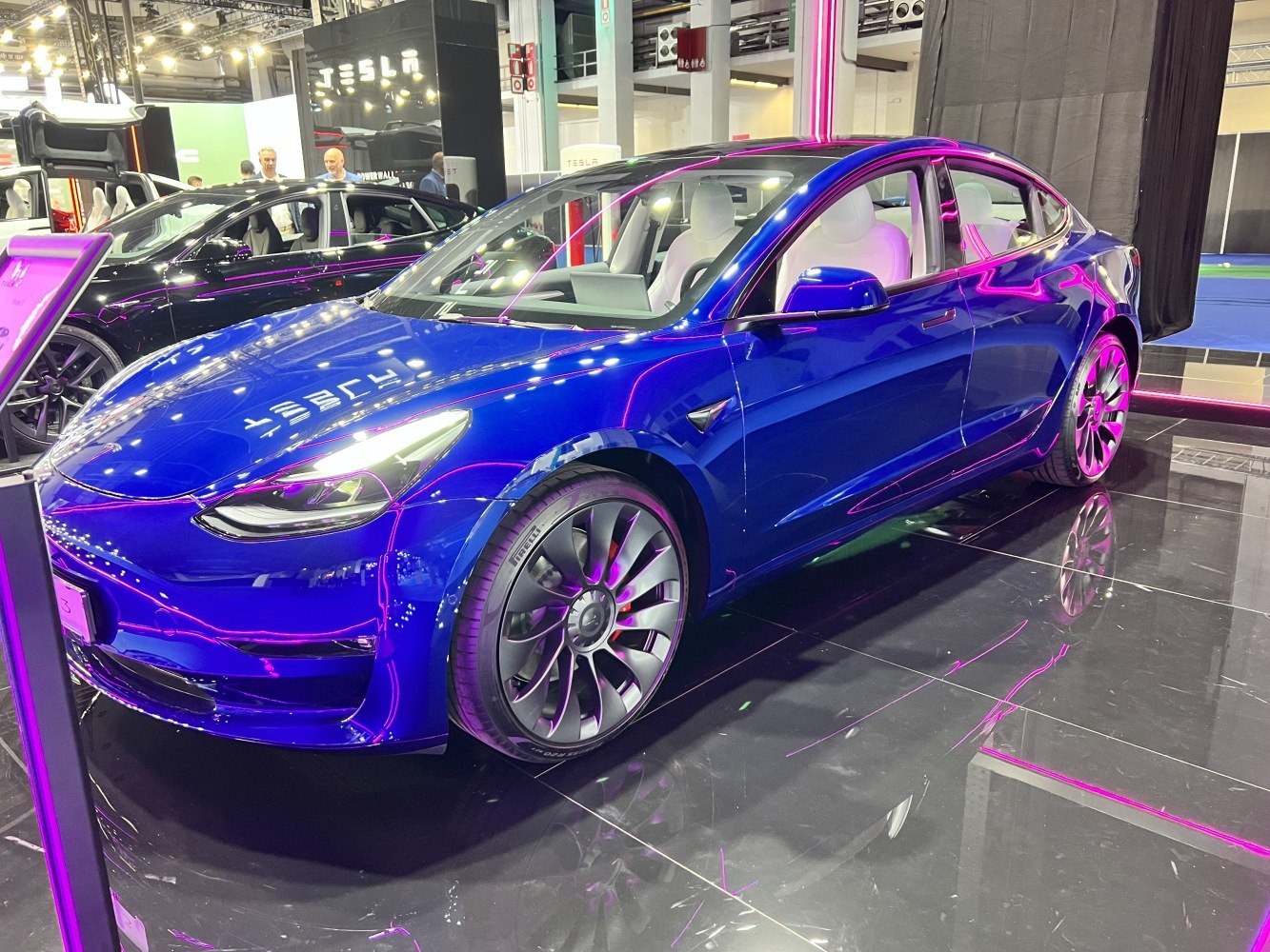 Blue electric sedan with LED headlights and alloy wheels