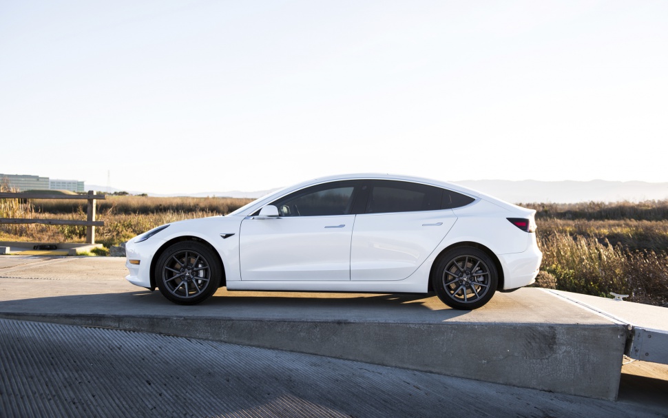 White electric sedan side profile with sleek aerodynamic styling