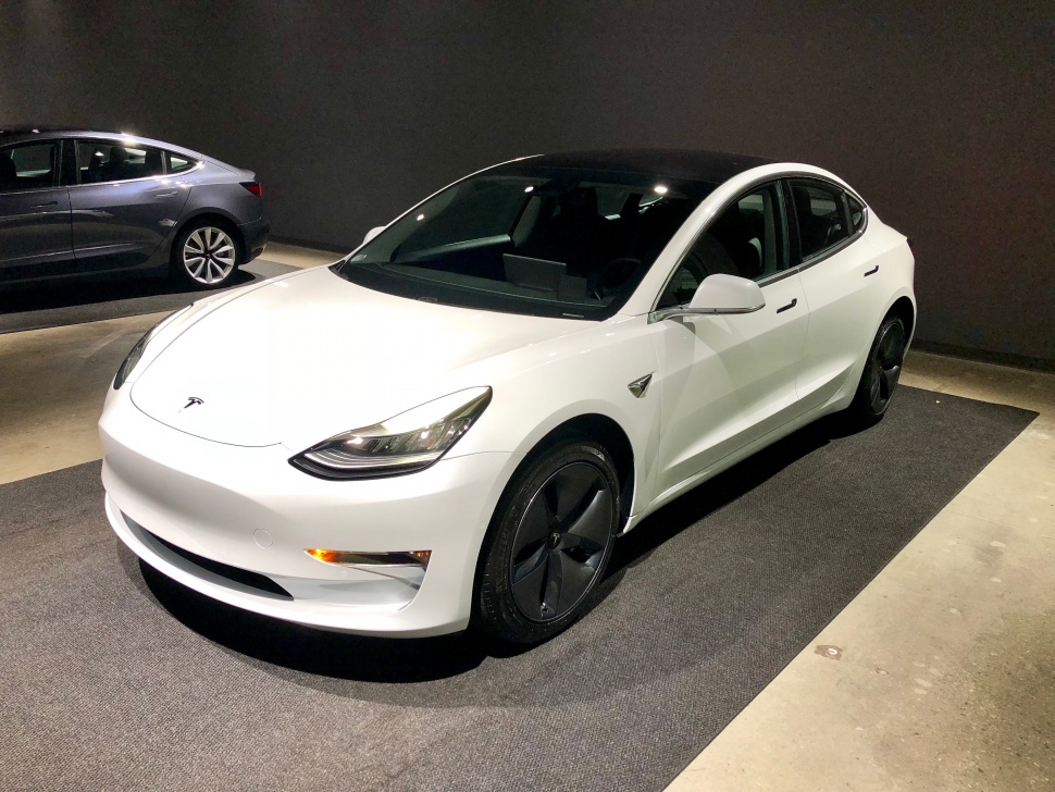 Electric sedan front side view with black roof