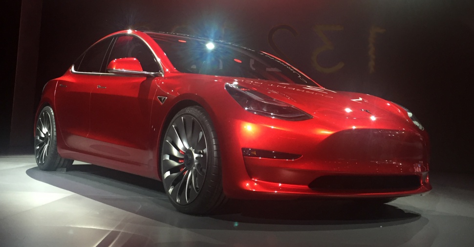 Front angle of electric sedan with aerodynamic body and turbine-style wheels