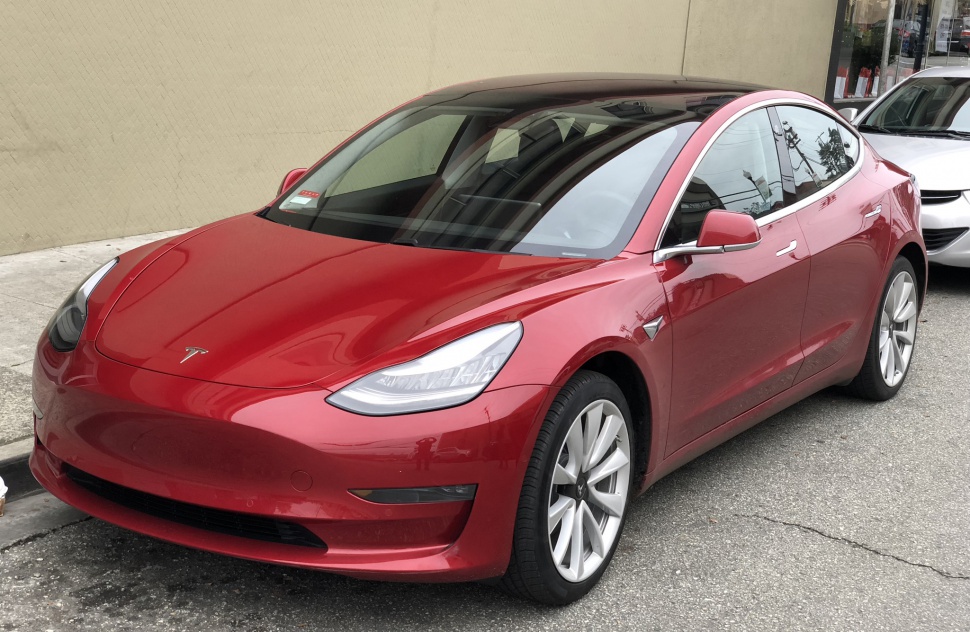 Sleek electric sedan with distinctive headlights and smooth aerodynamic body lines