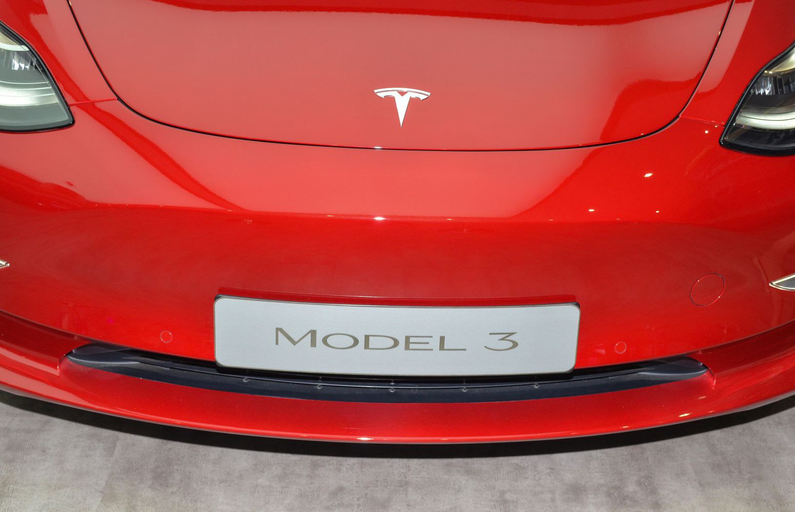 Close-up of Tesla Model 3 front bumper and emblem