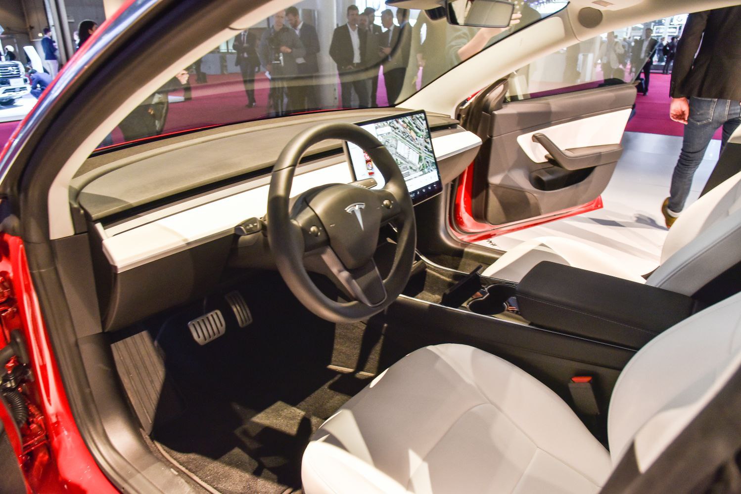 Minimalist car interior with central touchscreen and steering wheel