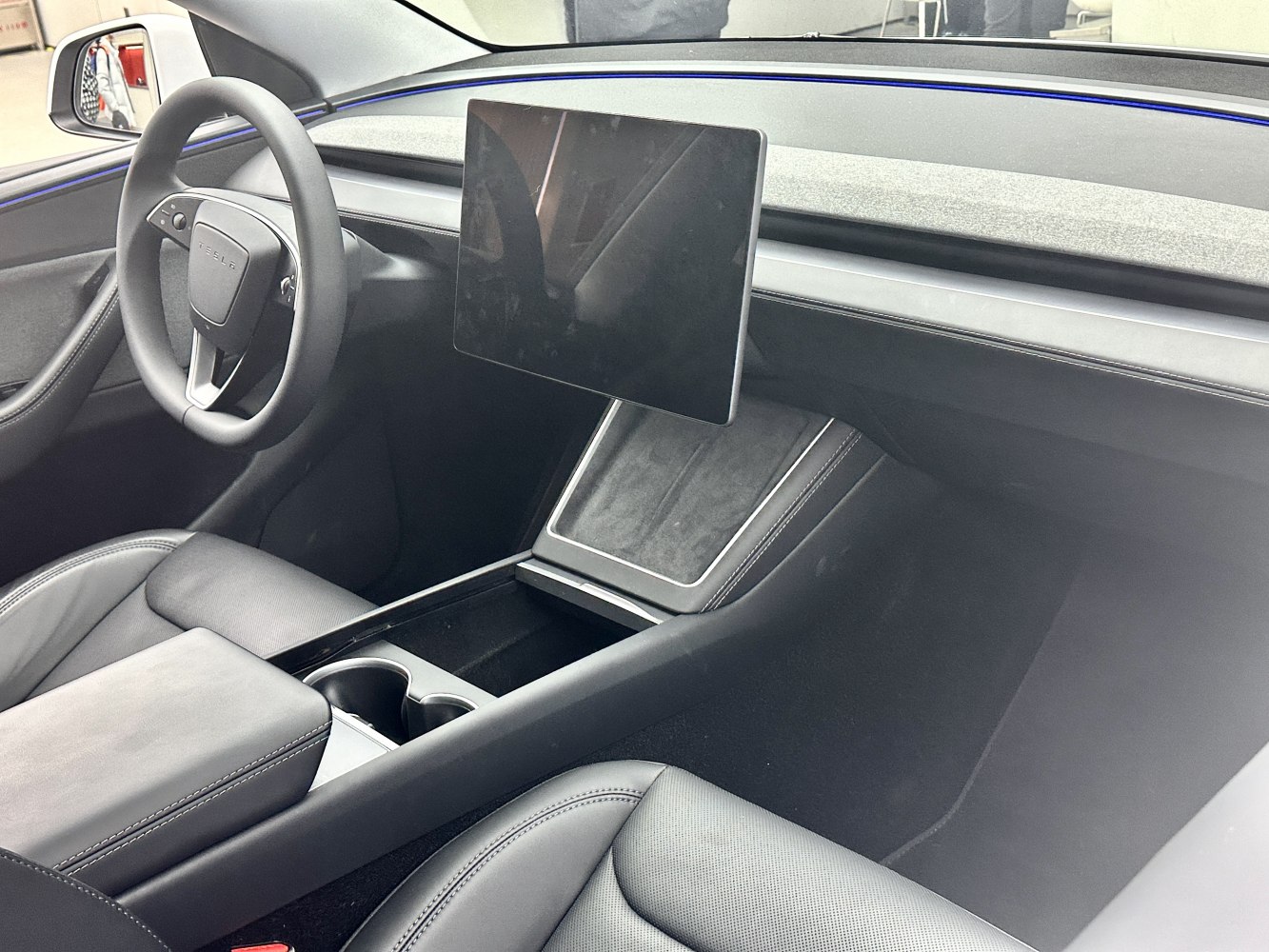 Floating touchscreen, minimalist dashboard, modern steering wheel