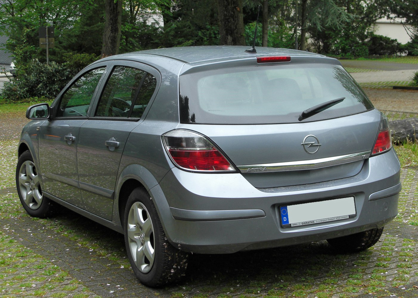Five-door hatchback rear view with tail lights and rear window wiper