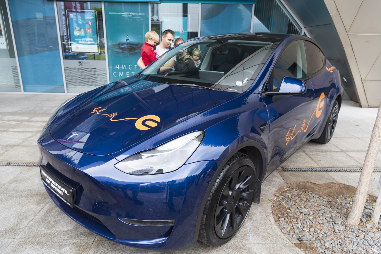 Sleek blue electric SUV with aerodynamic shape and black alloy wheels