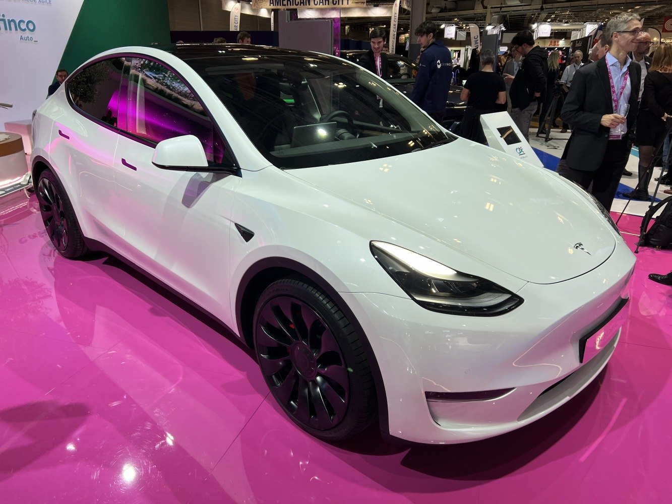 White electric SUV with black alloy wheels and aerodynamic shape.